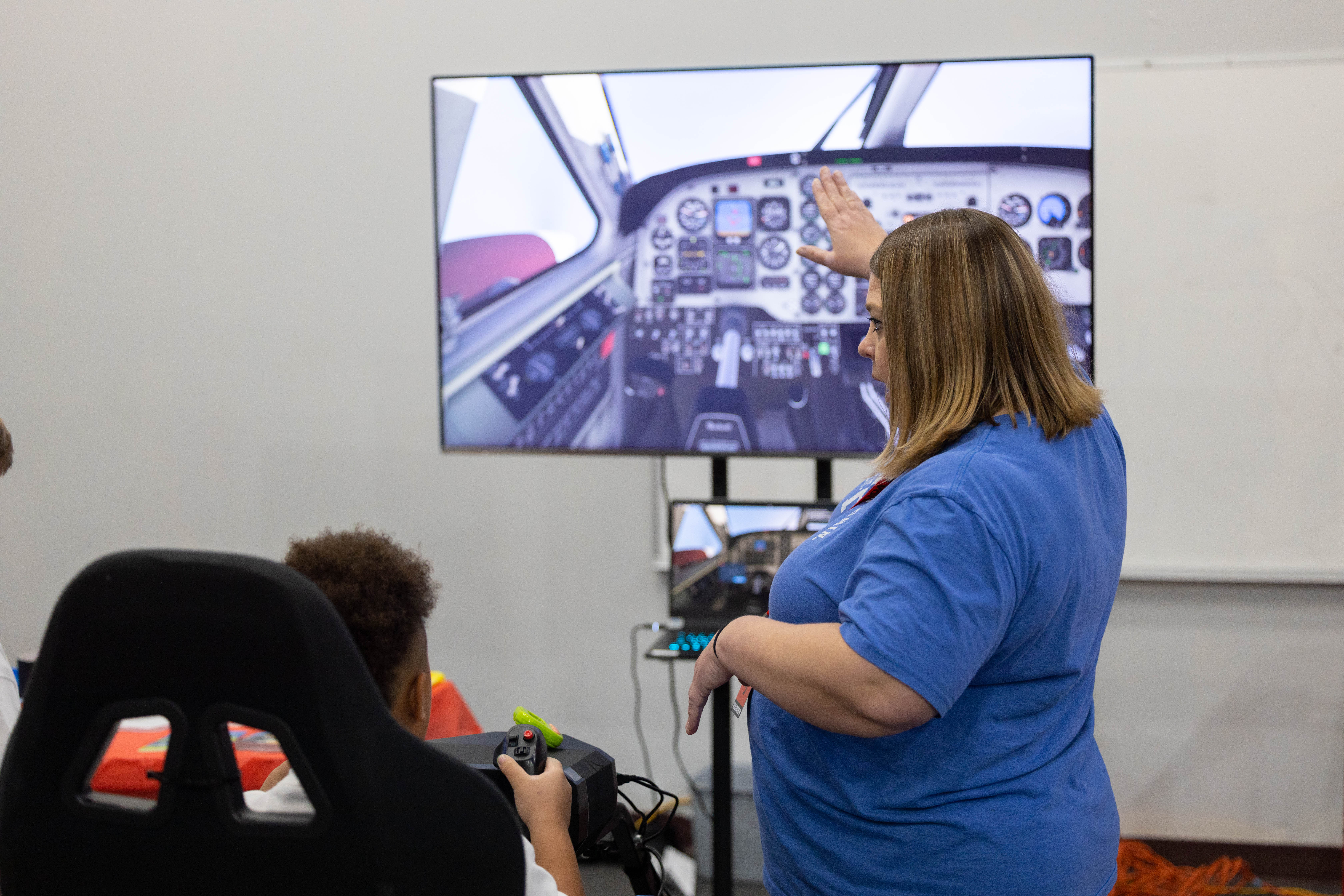 STEM Day at SJLS — student at flight simulator